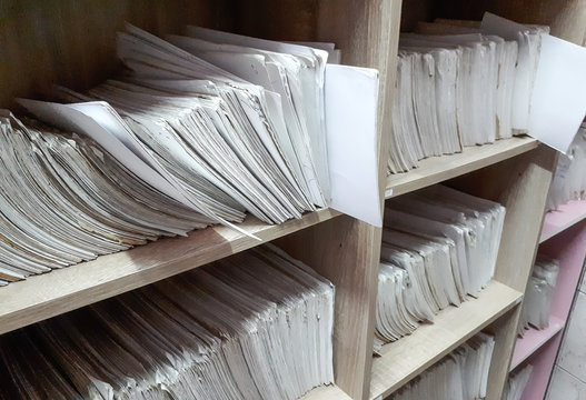 A cupboard full of paper files / inefficiency of paper based filing system