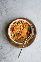 Meat stew in bowl with chickpeas, green Kale and vegetables. Slow cooked seasonal food