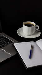 Office desk table with laptop, cup of coffee and other supplies. With copy space