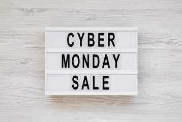 'Cyber monday sale' words on a modern board on a white wooden surface, top view. Overhead, from above, flat lay.