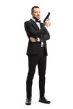 Man in a suit holding a gun