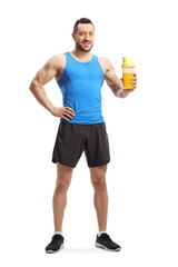 Young muscular man in sportswear with a protein shake