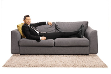 Fototapeta na wymiar Businessman resting on a sofa after work
