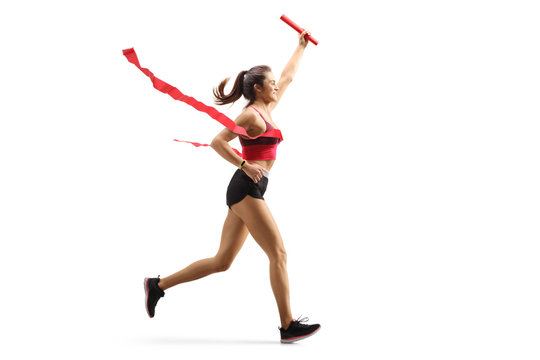 Female Runner On The Finish Line Of A Relay Race With A Baton In Her Hand