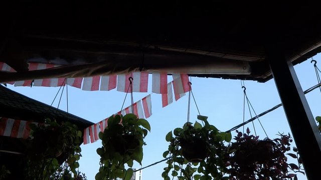 the atmosphere on the balcony of the house during the daytime. many flags because they are celebrating Indonesia's 74th independence