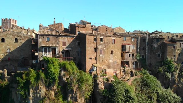 AERIAL TRUCK LEFT: Drone flying in Calcata Vecchia, a typical Italian medieval town standing on top of a mountain, an ancient community of thriving artists, the grooviest village in Italy