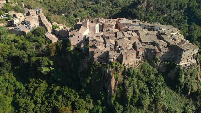 AERIAL TILT DOWN: Drone flying above Calcata Vecchia, a typical Italian medieval town standing on top of a mountain, an ancient community of thriving artists, the grooviest village in Italy