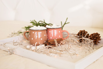 two christmas cups of coffee with marshmallows