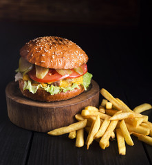 Beef hamburger ready to be served with fries