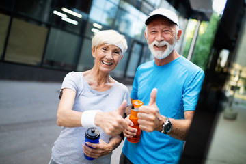 Fototapeta na wymiar Running mature couple congratulate and happy to finish their morning workout