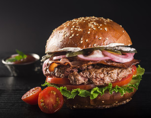 Delicious classic beef burger with cherry tomatoes