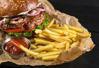 Classic take away burger with fries and ketchup