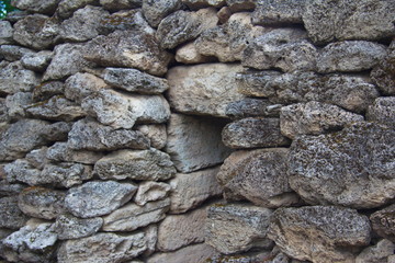Entrance to the stone cave. The stone wall of the pyramid