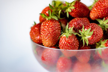 Fresh, red strawberry in a bowl, selective focus.
