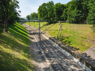 Railway among hill slopes with green grass.