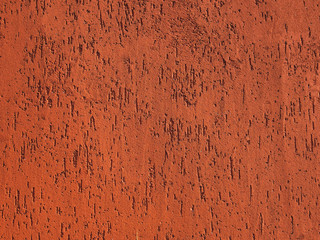 Abstract orange stone background with scratches and stains. Colorful backdrop with cracks.