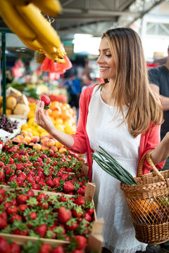 Picture of woman at marketplace buying vegetables