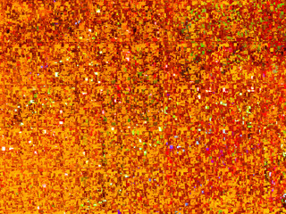 Bright golden background. Shiny and sparkling holographic orange backdrop. Top view, flat lay.