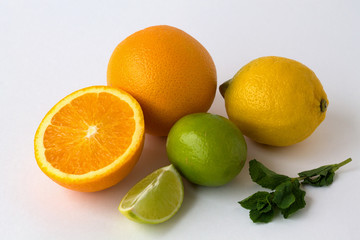 lemons and oranges with green leaves of mint isolated on white background