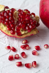 pomegranate with red seeds on a white background