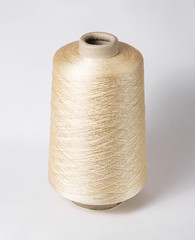 bobbin of yarn on a white background. Side view.Textile reel on isolated white background.