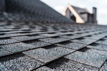 selective focus of grey shingles on rooftop of building - Powered by Adobe