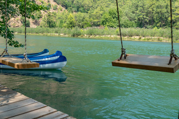 Wooden Swing and Conoe in Background