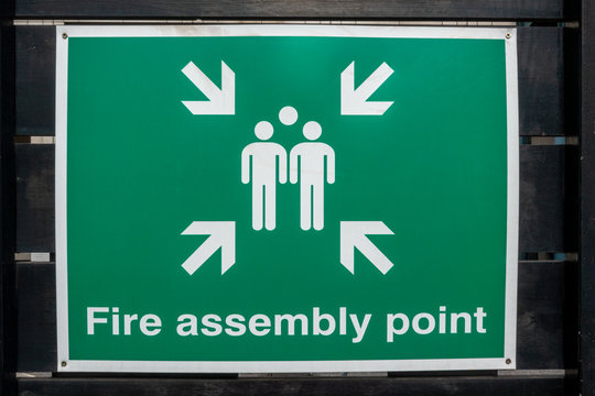 Fire Fire Assembly Point sign on a black fence