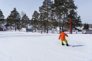 Snowboarder is riding with snowboard from snow hill.