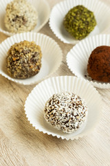 Various of round raw organic sweets with cacao chocolate and sesame. Homemade cooking