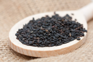Black sesame seeds in a spoon.
