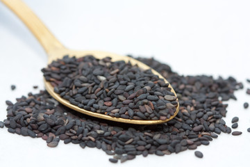 Black sesame seeds in a spoon.