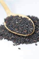 Black sesame seeds in a spoon.