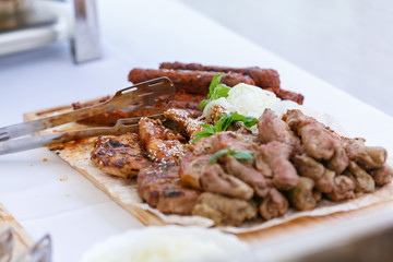 An upper view of fresh assorted barbeque on the wooden cutting board