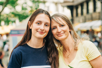 Outdoor portrait of young teenage girl with her mom