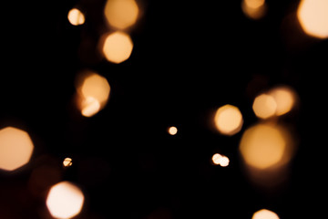 Golden abstract bokeh sparkle on black isolated background. Holiday concept. Place for design. Festive concept.