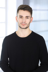 Beard man headshot at modern office. Businessman or student guy standing straight and smiling. Lifestyle concept