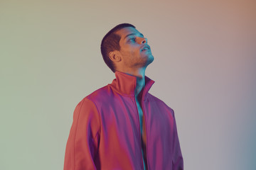 Studio close-up portrait of attractive male model. Color flash studio light