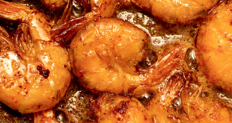 Shrimp fried in a pan in oil