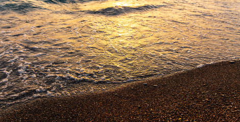 Waves on the seashore at sunset