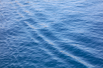 Blue expanse of water at sea as abstract background