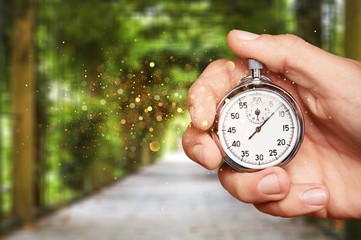 Metal classic stopwatch in the human hand
