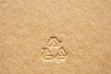 Fototapeta na wymiar recycle sign on brown cardboard paper texture background