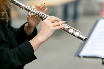 A closeup plane of street orchestra flute player © Ekaterina