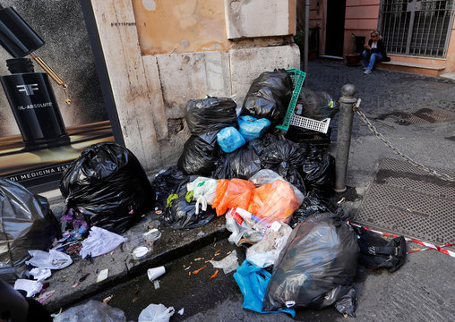 Piles of rubbish lie in downtown Rome