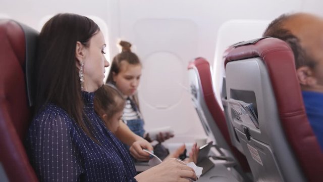 The woman feels ill during the flight on the plane.