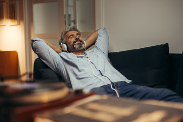 middle aged man listening music at his home