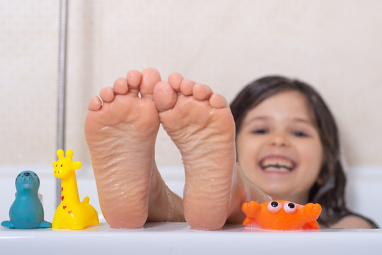 Baby Wash In The Bath. Little Girl Feet In The Bathtub. Bath Time. 