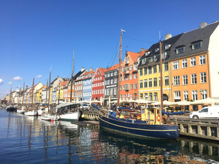 Fototapeta na wymiar Bright houses along and boats along the canal. Copenhagen.