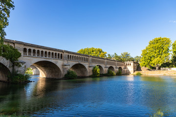 Naklejka premium The Orb Aqueduct, a bridge which carries the Canal du Midi over the Orb River in the city of Beziers in Languedoc-Roussillon, France.